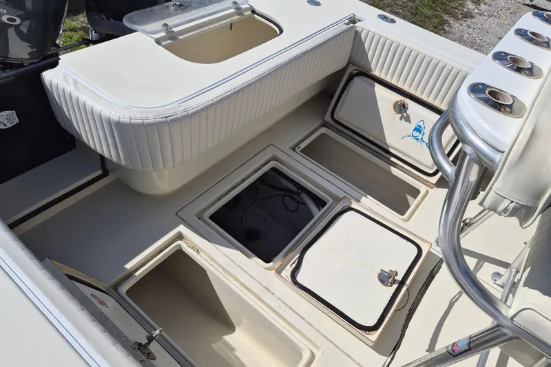Slide: The Image of 2008 Contender 23 Tournament boat interior with open storage compartments and seating. - 14