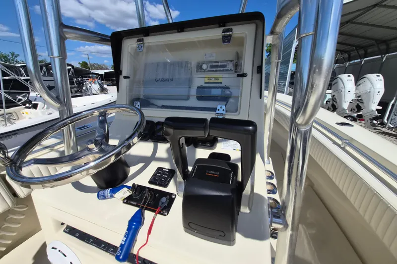 Slide: The Image of Console of a 2008 Contender 23 Tournament boat with steering wheel and controls. - 8