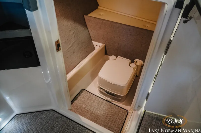 Slide: The Image of 2020 Cobalt R7 Surf boat interior with compact marine toilet. - 21