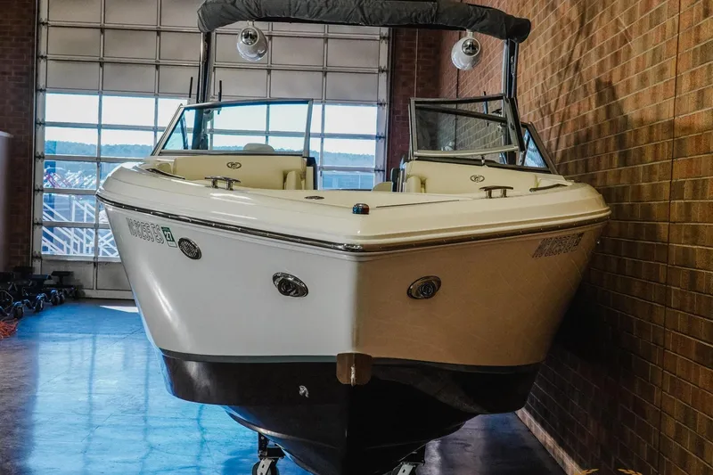 Slide: The Image of 2020 Cobalt R7 Surf boat in indoor storage, showcasing sleek design and modern features. - 4