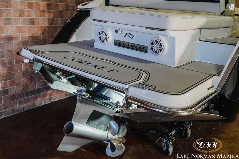 Slide: The Image of 2020 Cobalt R7 Surf boat at Lake Norman Marina, showcasing rear deck and propeller. - 7