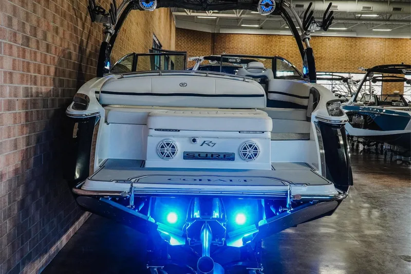 Slide: The Image of 2020 Cobalt R7 Surf boat with illuminated blue lights in showroom. - 9