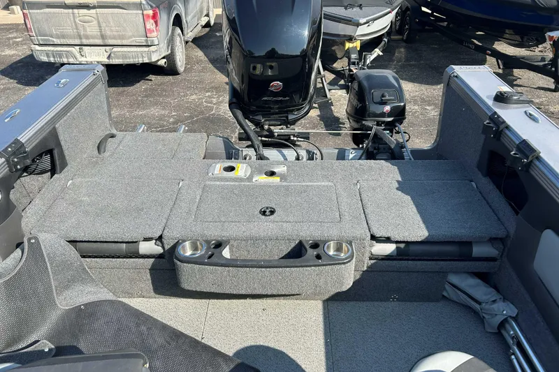 Slide: The Image of 2018 Lund 2075 Tyee boat interior with motor, cup holders, and seating area. - 10