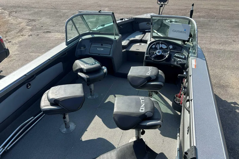 Slide: The Image of 2018 Lund 2075 Tyee boat interior with Garmin navigation system and swivel seats. - 11