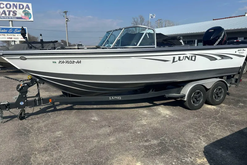 Slide: The Image of 2018 Lund 2075 Tyee boat on trailer in outdoor dealership lot. - 3