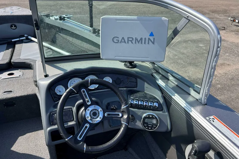 Slide: The Image of 2018 Lund 2075 Tyee boat dashboard with Garmin navigation system and steering wheel. - 7