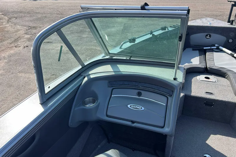 Slide: The Image of 2018 Lund 2075 Tyee boat interior with windshield and seating area. - 8