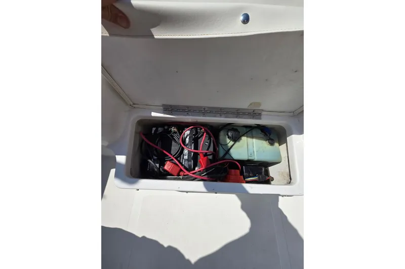 Slide: The Image of Storage compartment of a 2003 Sea Pro 206 Center Console boat with battery and cables. - 10