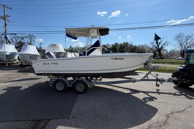 Slide: The Image of 2003 Sea Pro 206 Center Console boat on trailer under clear blue sky. - 18