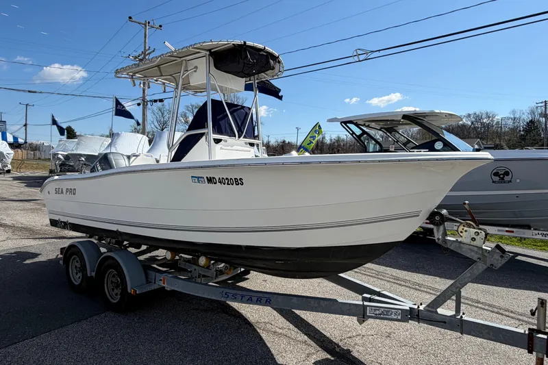Slide: The Image of 2003 Sea Pro 206 Center Console boat on trailer under clear blue sky. - 19