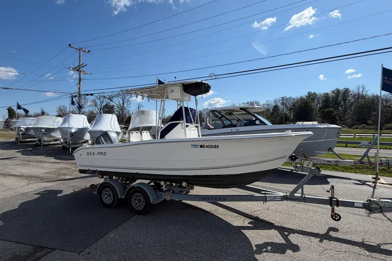 Slide: The Image of 2003 Sea Pro 206 Center Console boat on trailer, parked outdoors under a clear blue sky. - 20