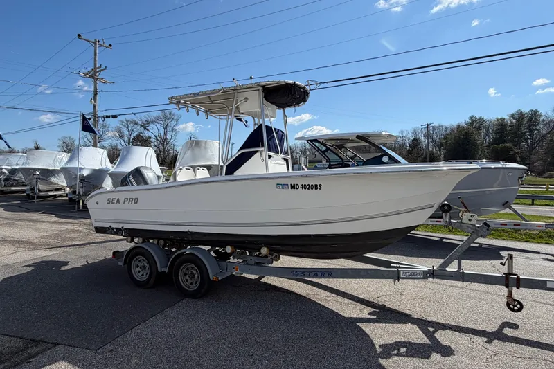 Slide: The Image of 2003 Sea Pro 206 Center Console boat on trailer, parked outdoors under clear sky. - 21