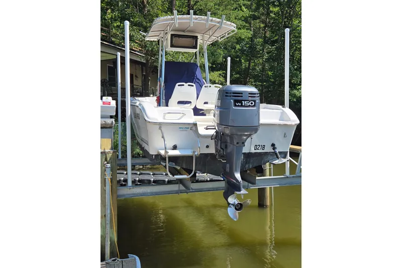 Slide: The Image of 2003 Sea Pro 206 Center Console boat with V6 150 engine on lift. - 3
