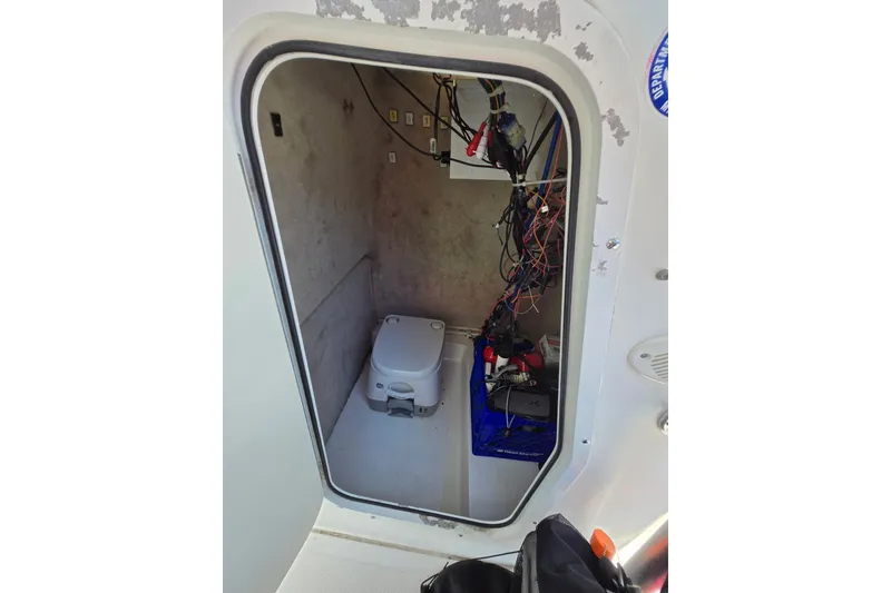 Slide: The Image of 2003 Sea Pro 206 Center Console boat interior with portable toilet and wiring. - 8