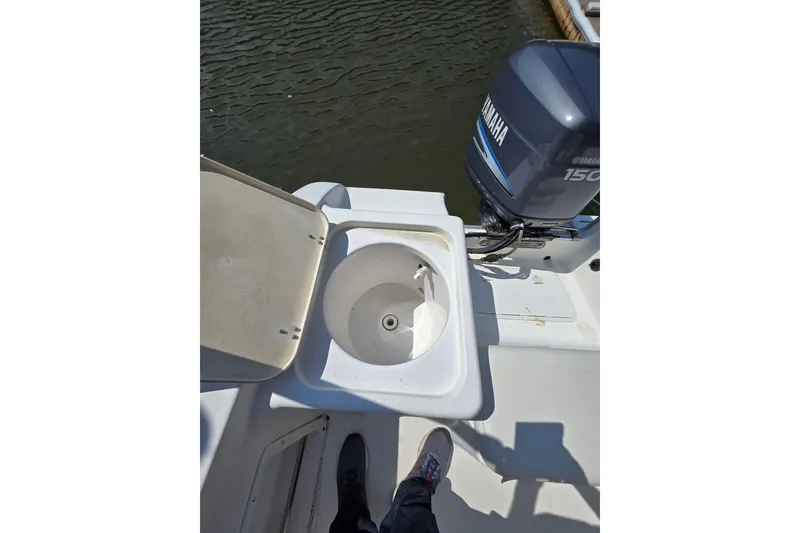 Slide: The Image of 2003 Sea Pro 206 Center Console boat with Yamaha 150 engine and open storage compartment. - 9