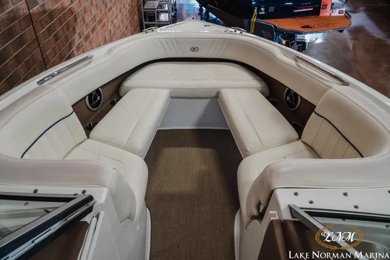 Slide: The Image of Interior of a 2011 Cobalt 242 WSS boat with white seating and carpeted floor. - 14