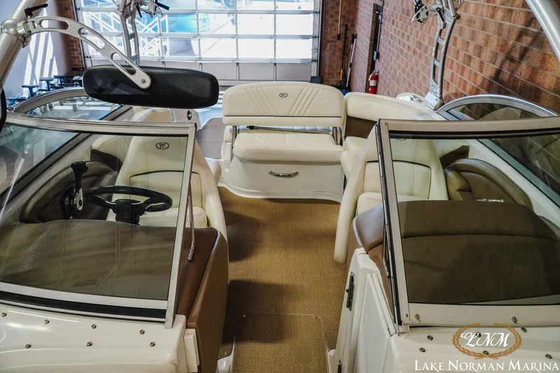 Slide: The Image of 2011 Cobalt 242 WSS boat interior with beige seating at Lake Norman Marina. - 15