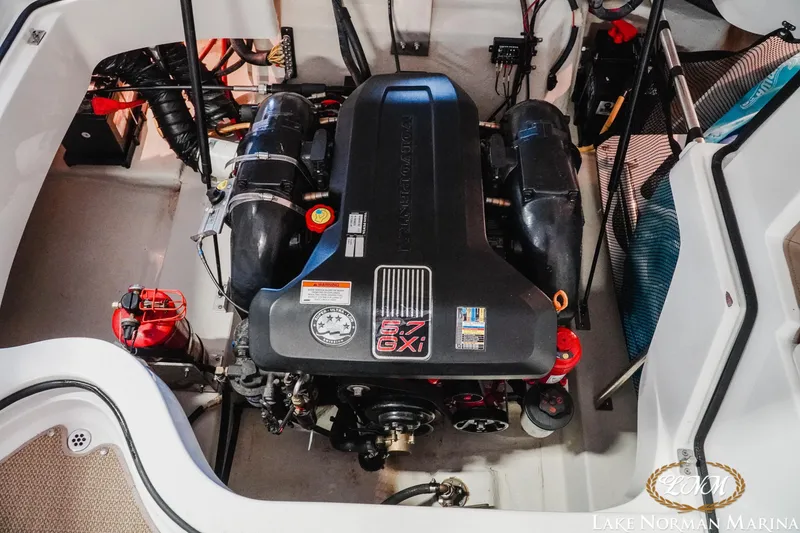Slide: The Image of Engine compartment of a 2011 Cobalt 242 WSS boat, featuring a 5.7 GXi engine. - 19