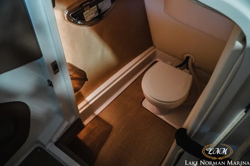 Slide: The Image of 2011 Cobalt 242 WSS boat interior with compact marine toilet. - 20