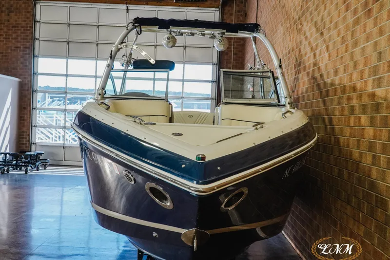 Slide: The Image of 2011 Cobalt 242 WSS boat in indoor storage, showcasing sleek design and modern features. - 3