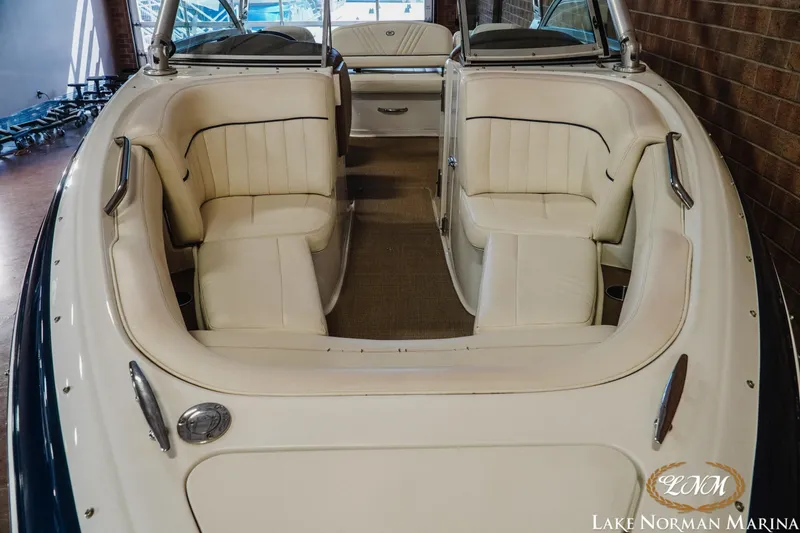 Slide: The Image of 2011 Cobalt 242 WSS boat interior with white seating at Lake Norman Marina. - 4