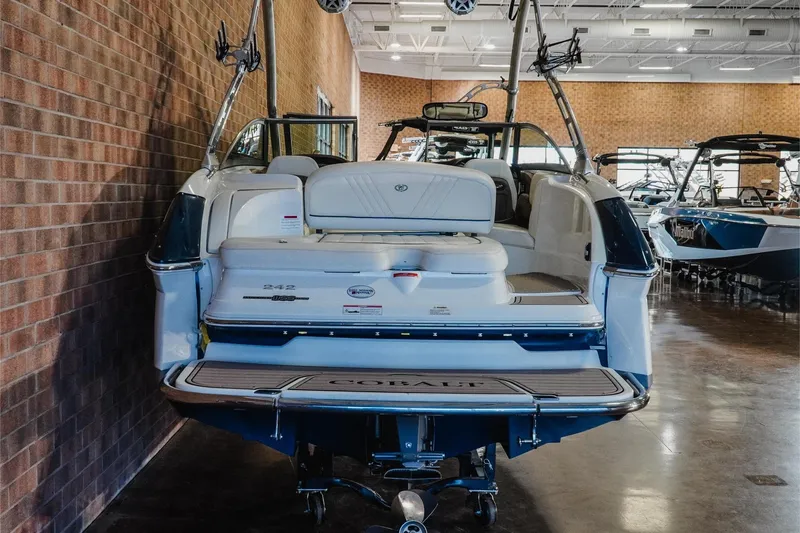 Slide: The Image of 2011 Cobalt 242 WSS boat displayed indoors, showcasing rear seating and swim platform. - 5