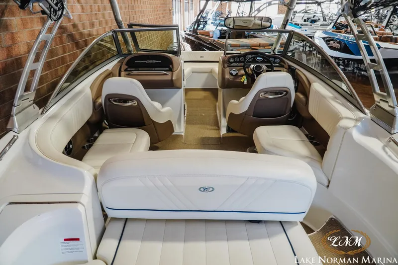 Slide: The Image of Interior of a 2011 Cobalt 242 WSS boat with white and brown seating. - 7
