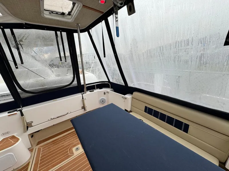 Slide: The Image of 2018 Ranger Tugs R-31S Ranger Tug interior with seating and table, enclosed by windows. - 11