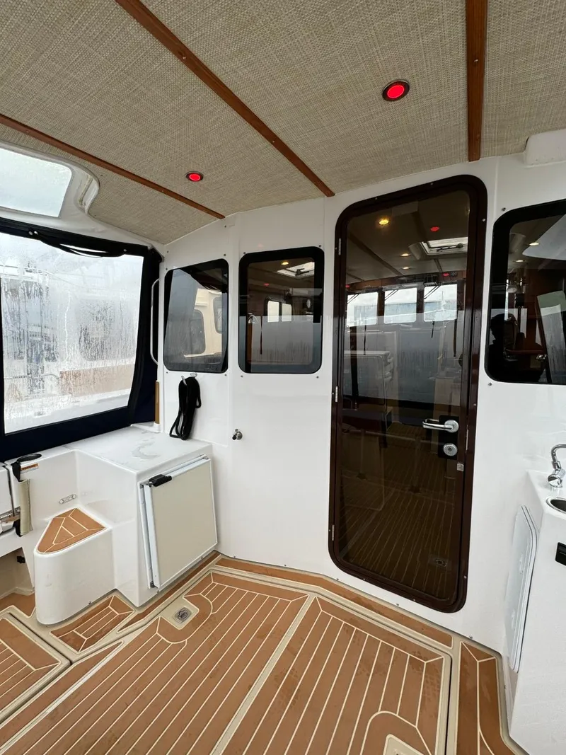 Slide: The Image of 2018 Ranger Tugs R-31S Ranger Tug interior with wood flooring and glass door. - 12