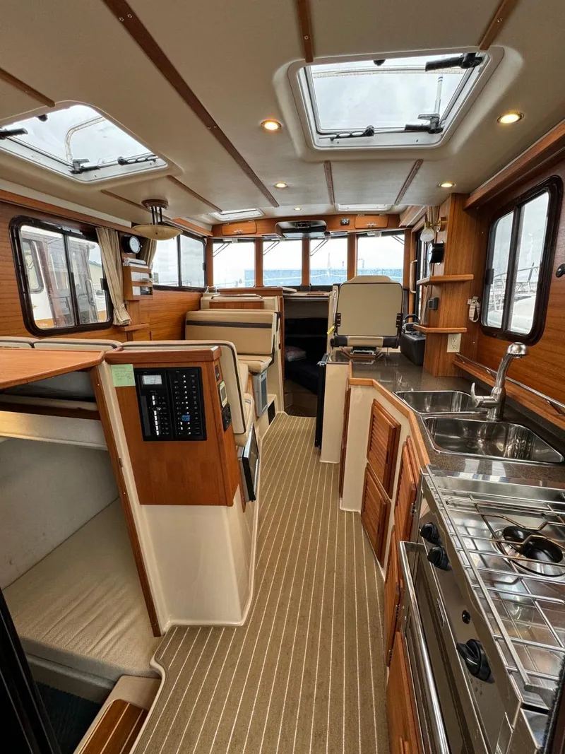 Slide: The Image of 2018 Ranger Tugs R-31S Ranger Tug interior with modern kitchen and cozy seating area. - 19