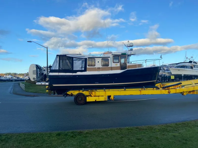 Slide: The Image of 2018 Ranger Tugs R-31S Ranger Tug on a yellow trailer under a blue sky. - 2
