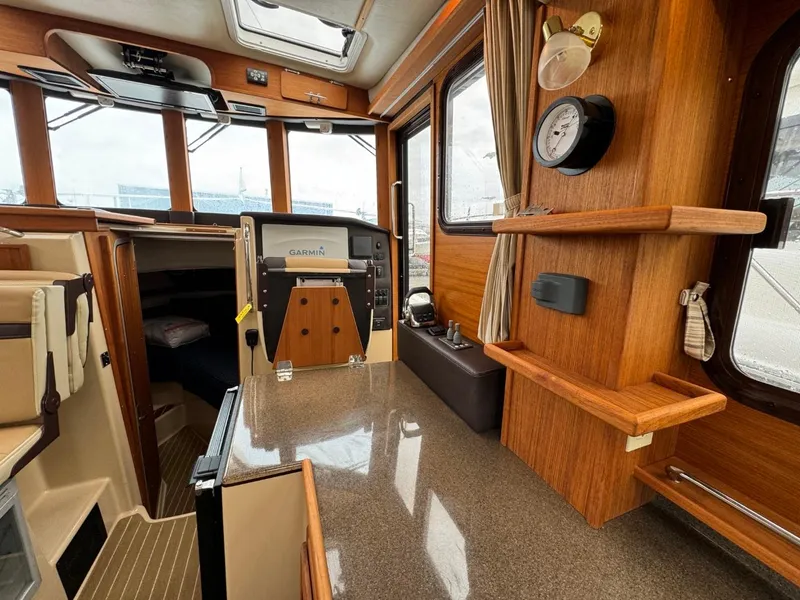 Slide: The Image of 2018 Ranger Tugs R-31S Ranger Tug interior with wood finish and navigation equipment. - 20