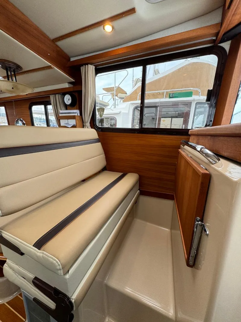 Slide: The Image of 2018 Ranger Tugs R-31S Ranger Tug interior seating area with window view. - 34