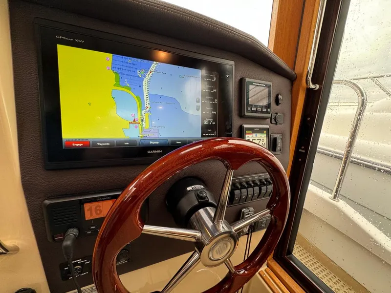 Slide: The Image of 2018 Ranger Tugs R-31S Ranger Tug helm with navigation display and wooden steering wheel. - 36