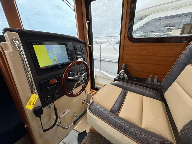 Slide: The Image of 2018 Ranger Tugs R-31S Ranger Tug helm with navigation system and leather captain's chair. - 37