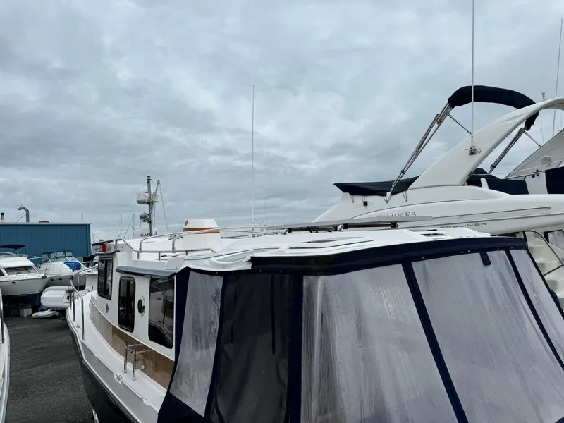 Slide: The Image of 2018 Ranger Tugs R-31S Ranger Tug docked at a marina under cloudy skies. - 6