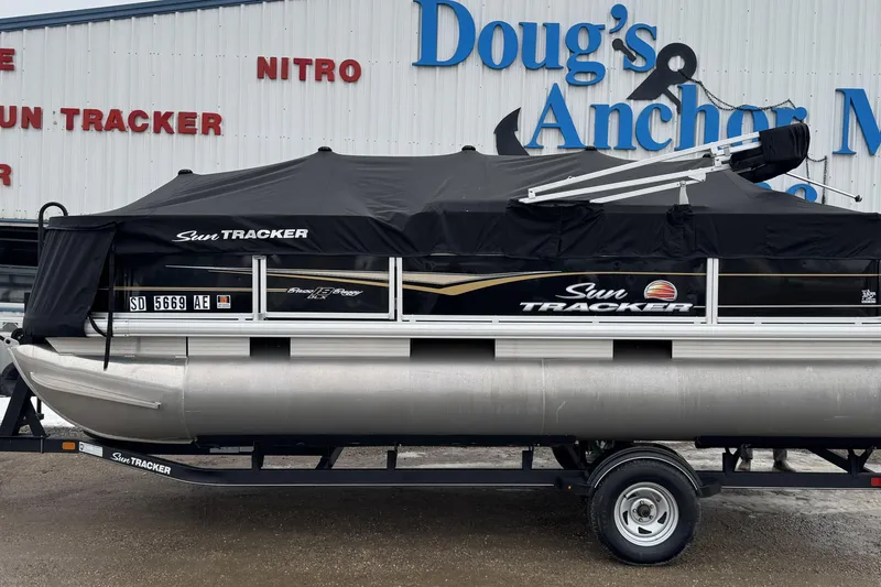 Slide: The Image of 2020 Sun Tracker Bass Buggy 18 DLX pontoon boat on trailer at dealership. - 10