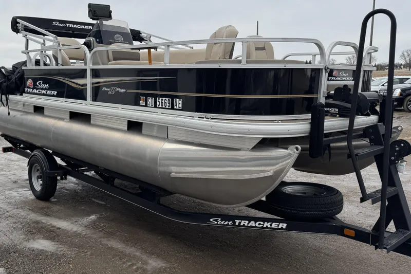 Slide: The Image of 2020 Sun Tracker Bass Buggy 18 DLX pontoon boat on trailer in parking lot. - 3