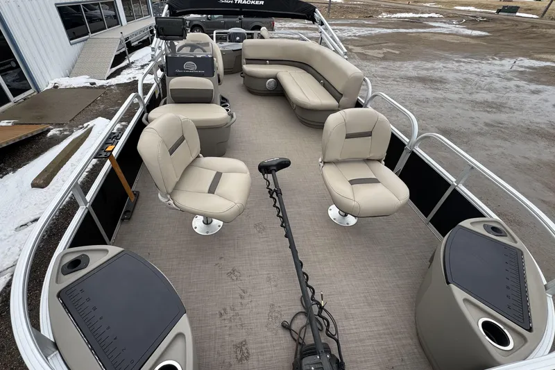 Slide: The Image of 2020 Sun Tracker Bass Buggy 18 DLX pontoon boat with beige seating and fishing features. - 6