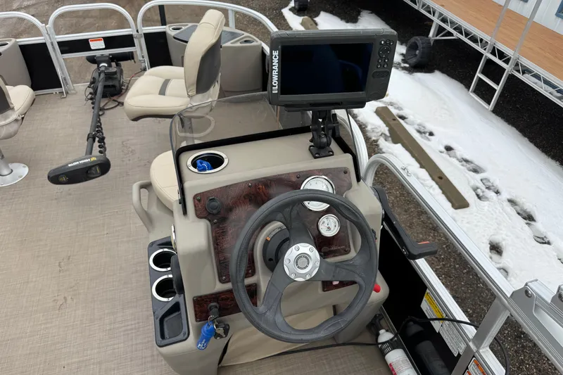 Slide: The Image of 2020 Sun Tracker Bass Buggy 18 DLX boat dashboard with steering wheel and navigation system. - 8