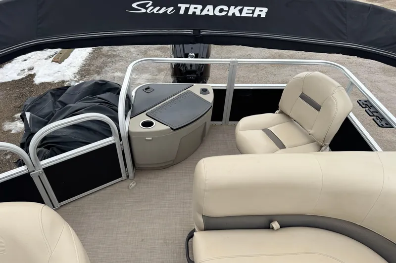 Slide: The Image of 2020 Sun Tracker Bass Buggy 18 DLX pontoon boat interior with beige seating. - 9