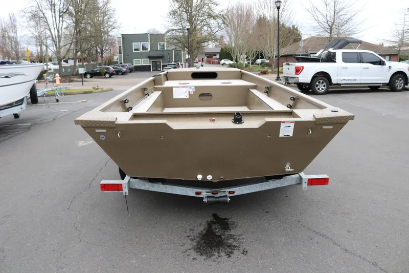Slide: The Image of 2026 Smoker Craft Sportsman 1660 boat on trailer, parked outdoors. - 13