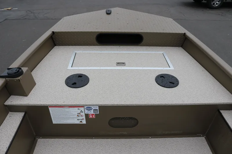 Slide: The Image of 2026 Smoker Craft Sportsman 1660 boat interior with storage compartments and non-slip flooring. - 5