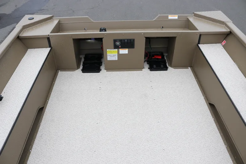 Slide: The Image of 2026 Smoker Craft Sportsman 1660 boat interior with storage compartments and seating. - 8