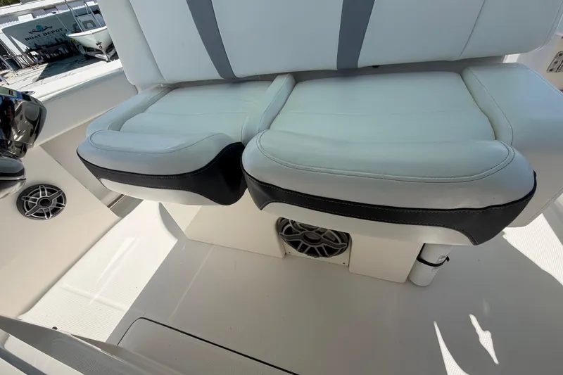 Slide: The Image of 2020 Robalo R272 Center Console boat seating with integrated speakers. - 13