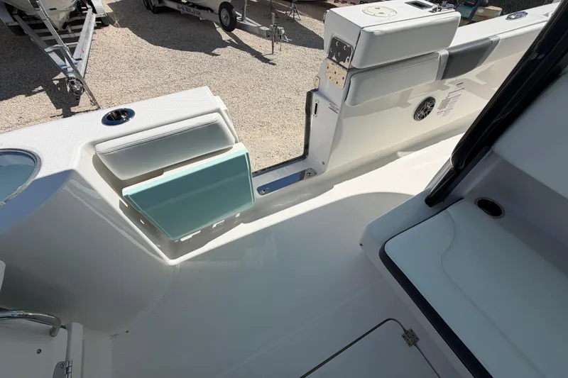 Slide: The Image of 2020 Robalo R272 Center Console boat interior with seating and storage compartments. - 16