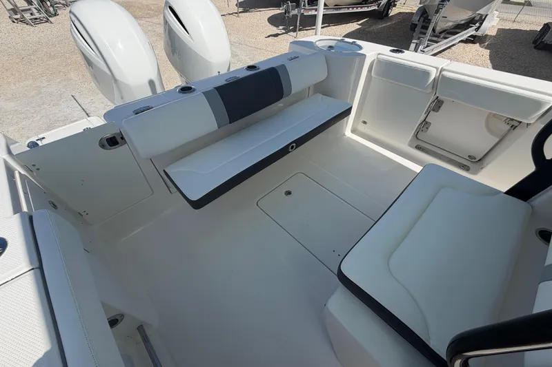 Slide: The Image of 2020 Robalo R272 Center Console boat interior with seating and storage compartments. - 18