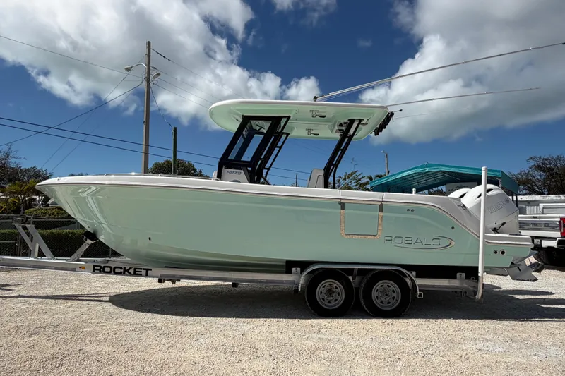 Slide: The Image of 2020 Robalo R272 Center Console boat on trailer under blue sky. - 4