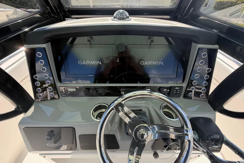 Slide: The Image of 2020 Robalo R272 Center Console dashboard with Garmin displays and steering wheel. - 5