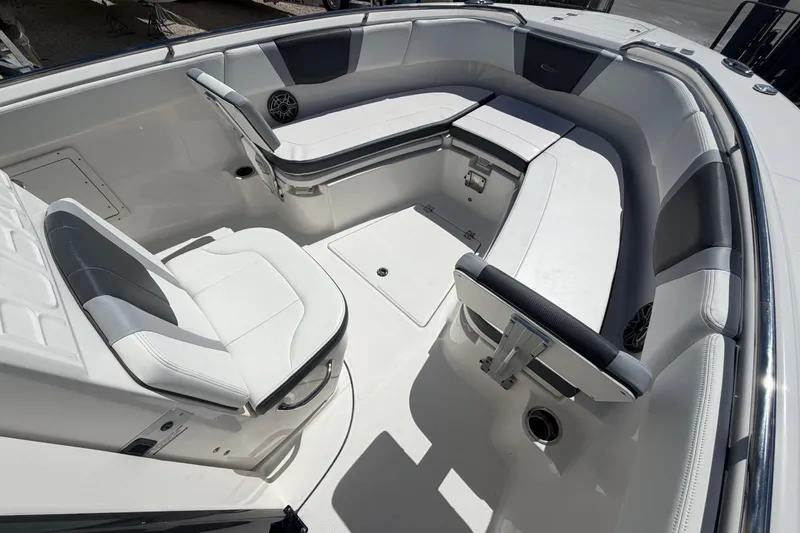 Slide: The Image of 2020 Robalo R272 Center Console boat interior with white cushioned seating. - 8
